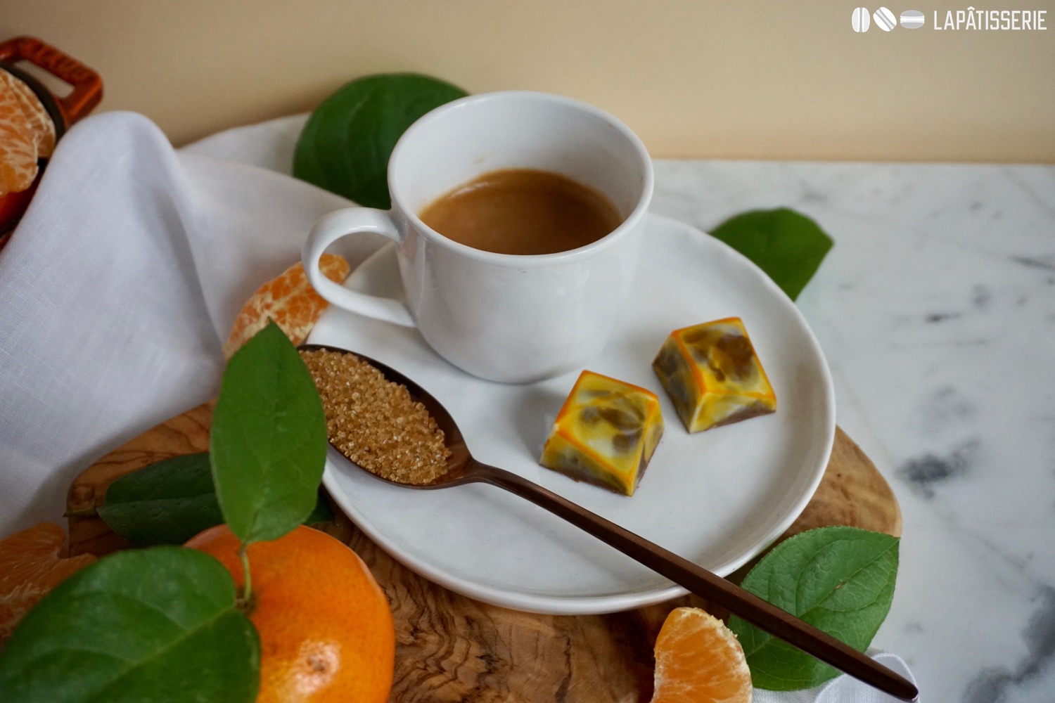 Eine Tasse Kaffee und dazu ein paar Pralinen mit Mandarine und Vollmilchschokolade.